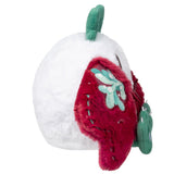 Plush toy resembling a strawberry with green leaves on a white background