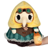 Plush toy with a yellow hood, green outfit, and goggles on a white background