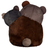 Plush toy resembling a bear with brown, gray, and black fur on a white background