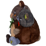 Plush toy of a beaver holding a branch on a white background