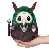 Plush toy with green hood and brown body held in a hand on a white background