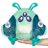 Plush toy with teal and green colors held by a hand on a white background