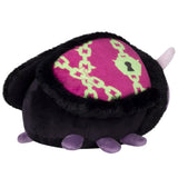 Black plush toy with a pink and green patterned heart on a white background