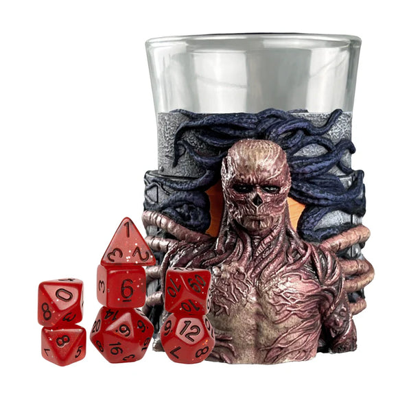 Glass with monster design, red dice, and glass on a white background