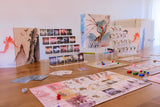 Board game setup on a table with various game pieces and cards.