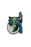 Enamel pin of a baby dragon hatching from an egg on a white background