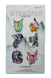Packaged set of Wyrmspan enamel pins with colorful dragon designs on a white background.