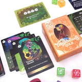 Card game components including cards, dice, and a box labeled 'Tanglewood Gold' on a white background.