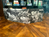 Decorative box with black and white illustration on a wooden surface