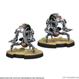 Two sci-fi robot miniatures on round bases with grass texture against a white background.