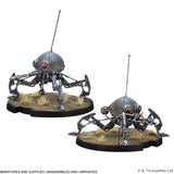 Two metallic robot figures on round bases with grass texture, on a white background.