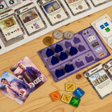 Board game components including cards and dice on a wooden surface