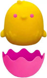 Yellow creature toy with pink shell on a white background