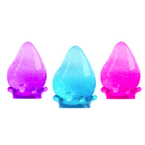 Three colorful plastic toys shaped like teardrops on a white background