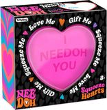 Pink heart-shaped toy with text on a colorful box