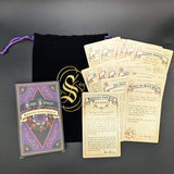 Collection of cards and a purple drawstring bag on a dark surface