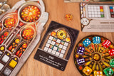 Board game components including dice and cards on a wooden surface