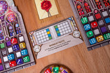 Colorful dice sets and a card labeled 'Minimalist Palette' on a wooden surface