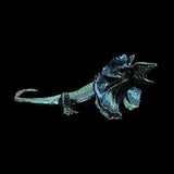 Metallic blue lizard figurine on a black background