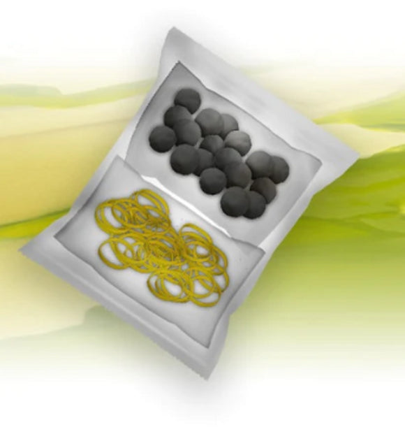 Box containing black rubber balls and yellow rubber bands on a white background