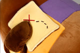 Plush toy resembling a map on a brown surface