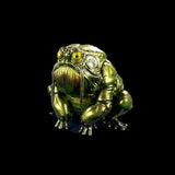 Metallic frog figurine on a black background