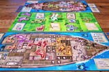 Board game with colorful pieces and cards on a wooden surface
