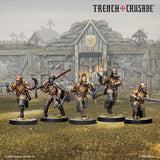 Five miniature figures from the game 'Trench Crusade' in front of a trench warfare backdrop.