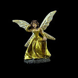Fairy figurine with gold dress and wings on a black background