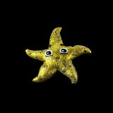 Gold starfish with black and white eyes on a black background