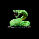 Green snake figurine on a black background