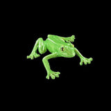 Green frog figurine on a black background