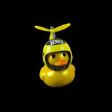 Yellow rubber duck with a helmet and propeller on a black background