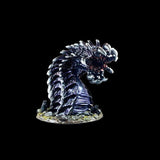 Monster figurine with a dark, textured surface on a black background