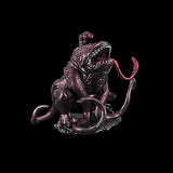 Metallic froghemoth figurine with red eyes and open mouth on a black background