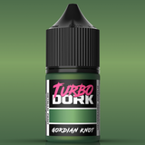 Bottle of Turbo Dork Gordian Knot paint on a green background