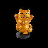 Wooden cat figurine with open arms on a black background