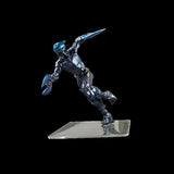 Metallic figurine of a warrior with a weapon on a black background