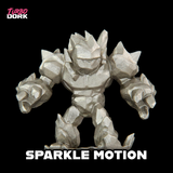 Metallic robot figurine with 'Turbo Dork' branding and 'Sparkle Motion' text on a black background.