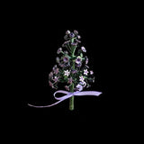 Decorative flower arrangement with a purple ribbon on a black background