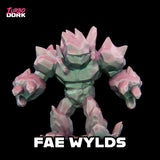 Toy figure of a creature with pink and green colors on a black background, branded 'Turbo Dork'.
