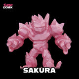 Pink robot-like figure with 'Sakura' text and 'Turbo Dork' logo on a black background