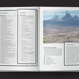 Open book showing a desert landscape with mountains and text on the left page.