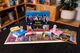 Board game set with 'Battle of Versailles' box on a table