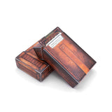 Wooden jewelry box with a metallic label on a white background