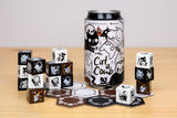 Cat-themed board game pieces including dice and hexagonal tiles on a wooden surface.