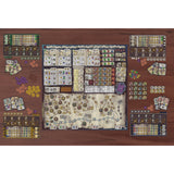 Board game setup with various components on a wooden surface