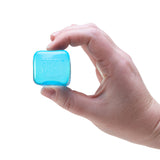 Hand holding a blue square object against a white background
