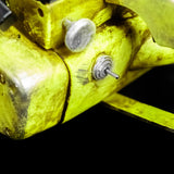 Close-up of a yellow metal clamp with screws on a black background
