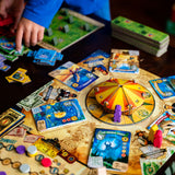 Board game with colorful cards and pieces on a wooden table